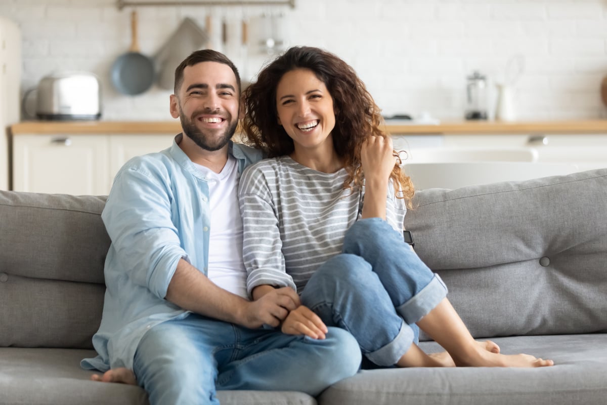 A couple smiling in their home