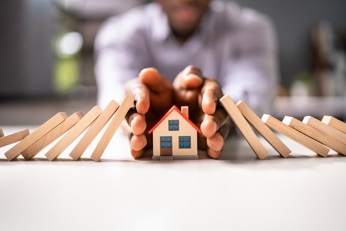 A man protecting a model house