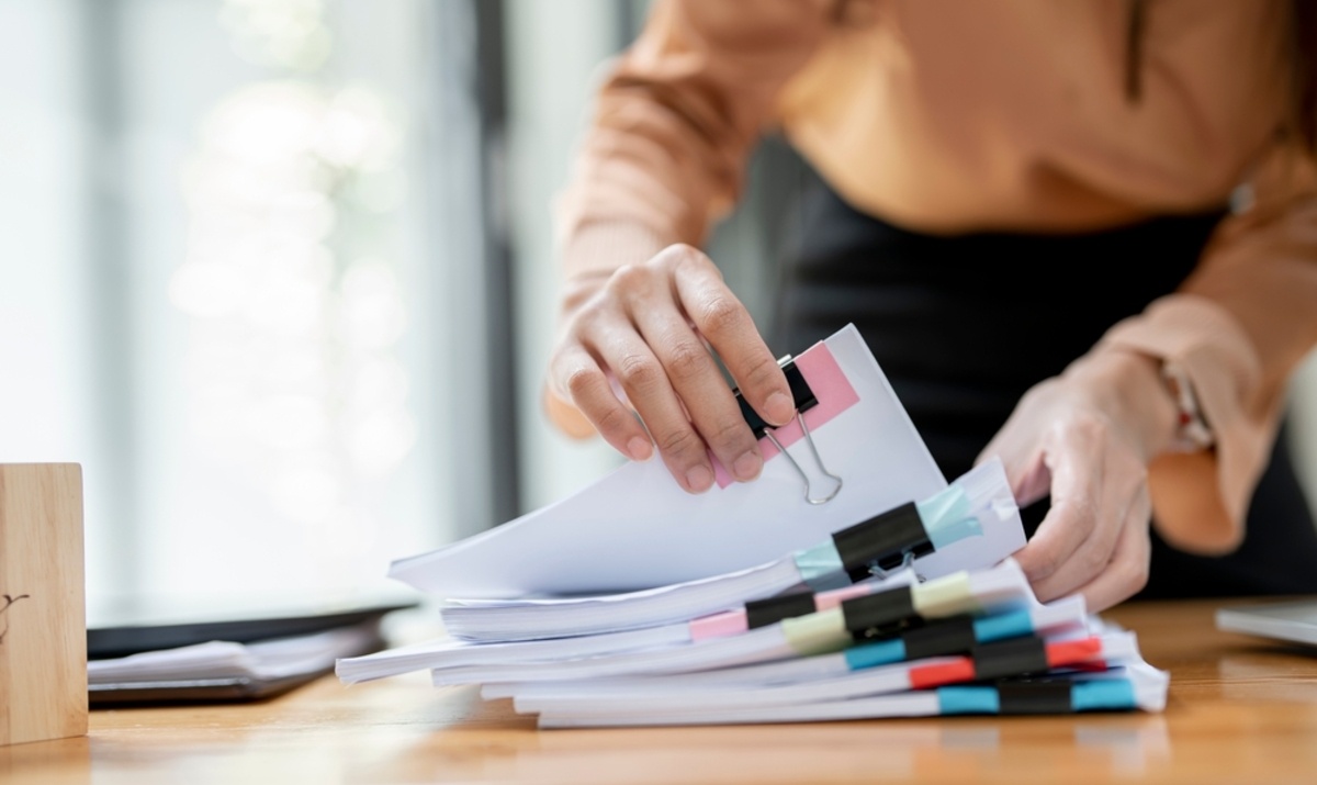 Businesswoman looking through organized documents