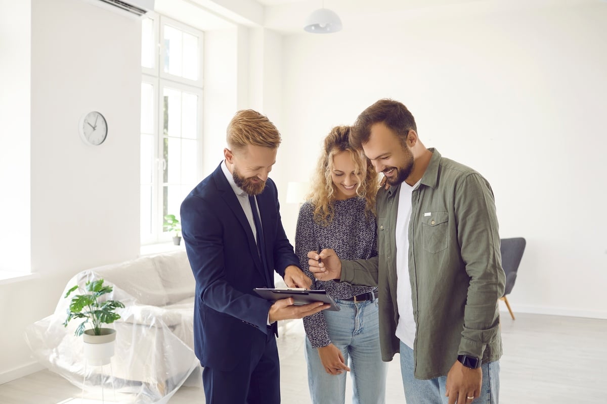 Happy couple signing a document in a home